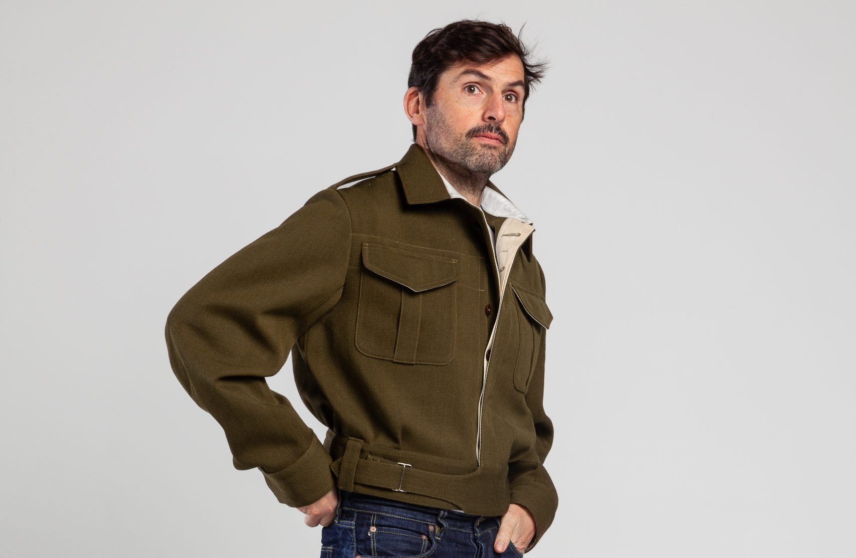 A model wearing the AVRE battle jacket looking off into the distance
