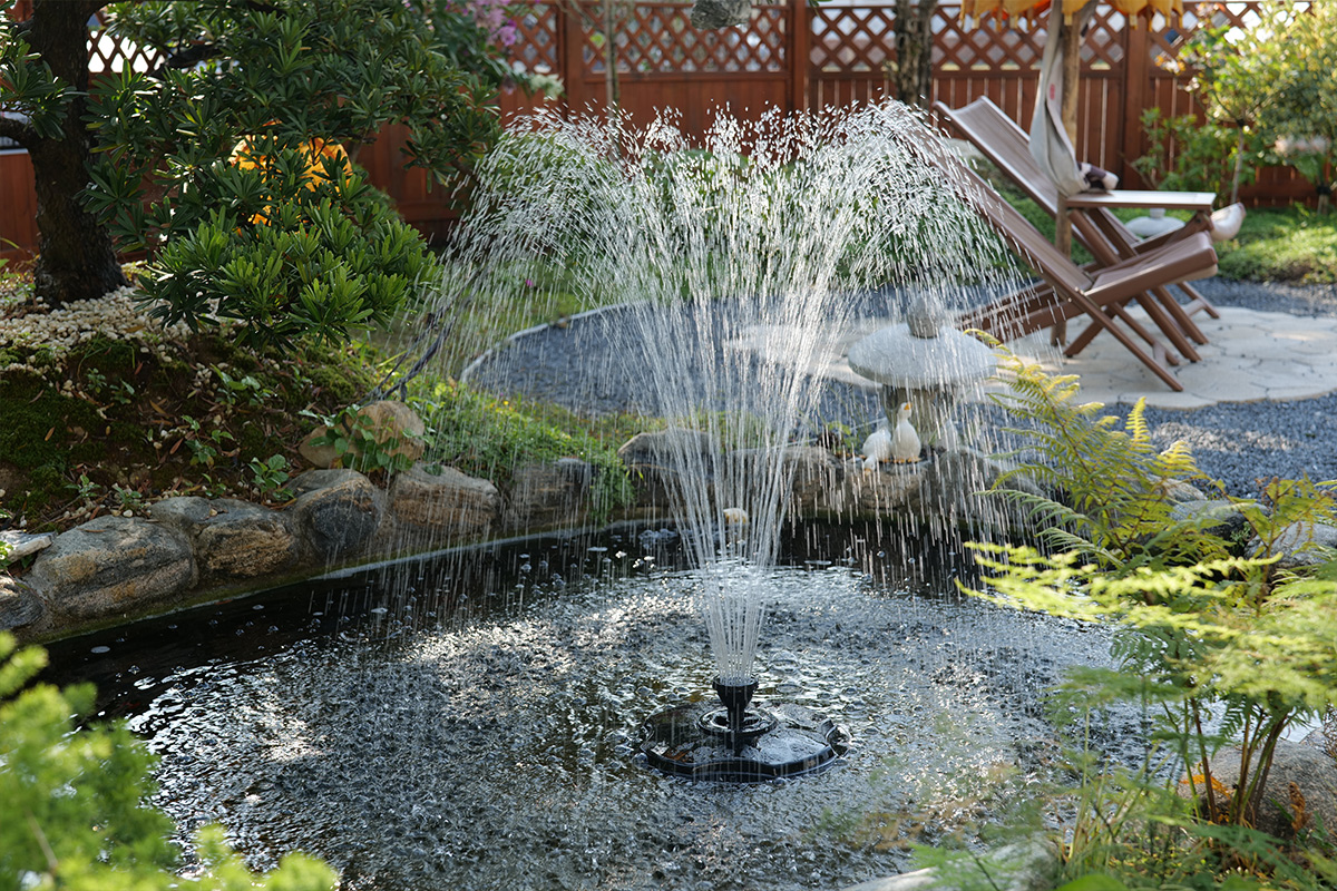 Poposoap Solar fountain creating an elegant multi-jet water display, adding movement and visual interest to a landscaped garden pond.