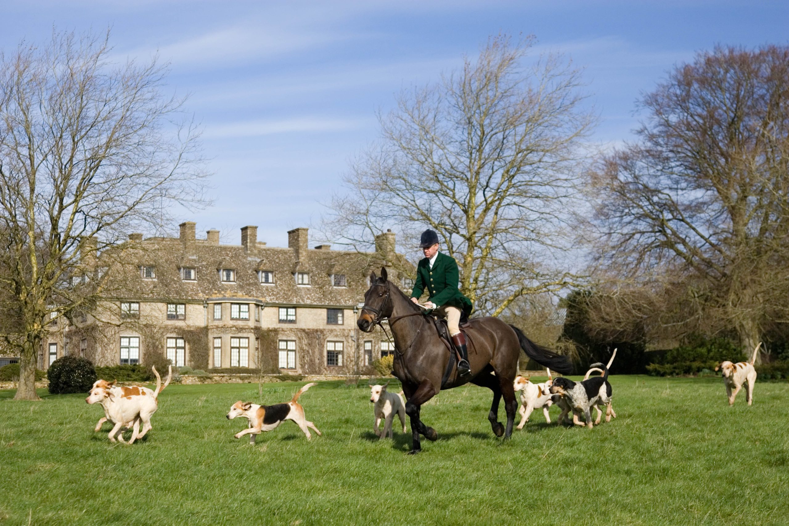 GREAT BRITAIN - MARCH 05: Member of Heythrop Hunt rides with hounds at traditional Hunt Meet on Swinbrook House Estate in Oxfordshire, United Kingdom (Photo by Tim Graham/Getty Images)