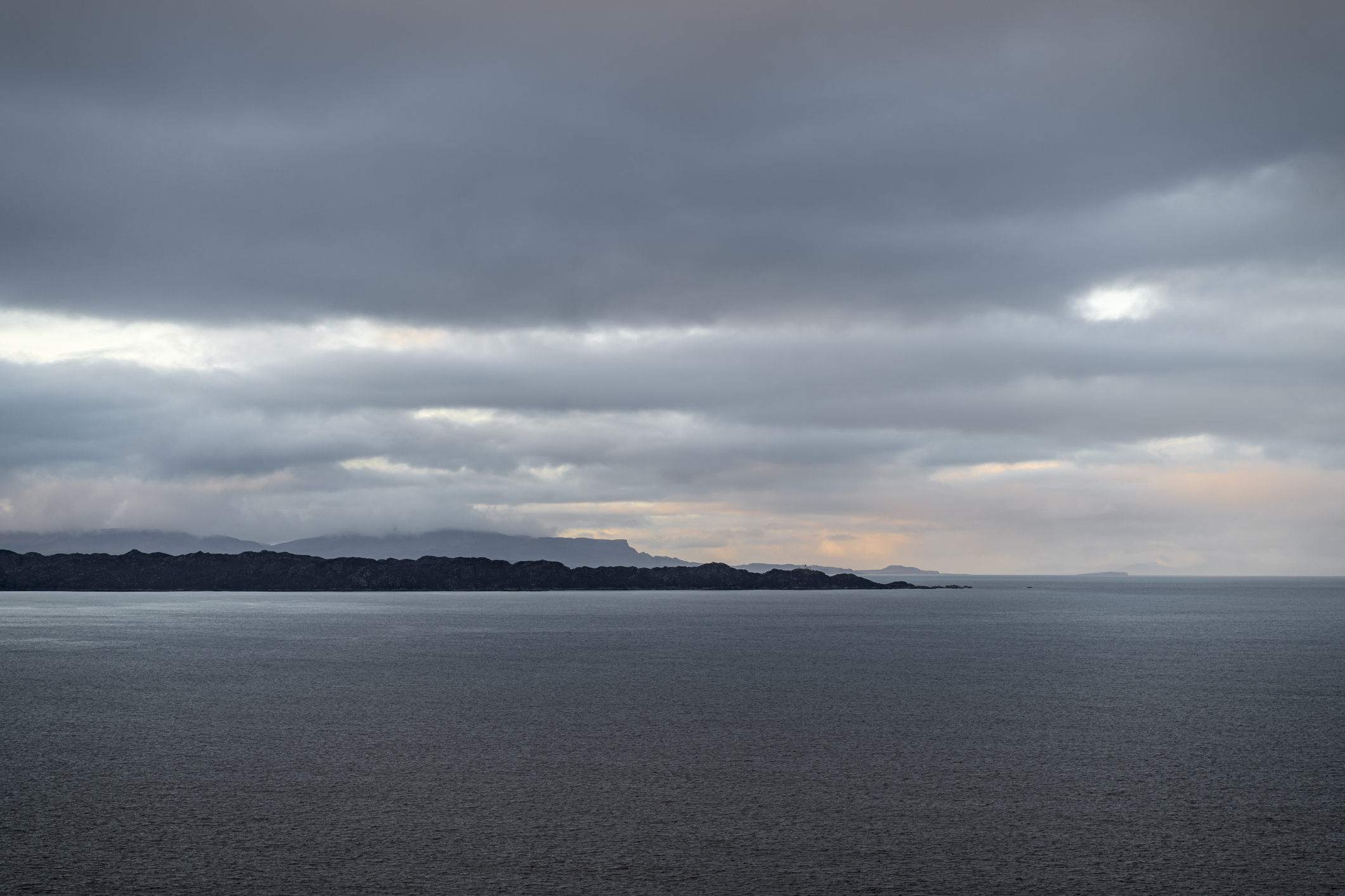 A three shot Bracketed image of late afternoon light and rain across the Inner Sound and South Rona, Scotland. 23 December 2019