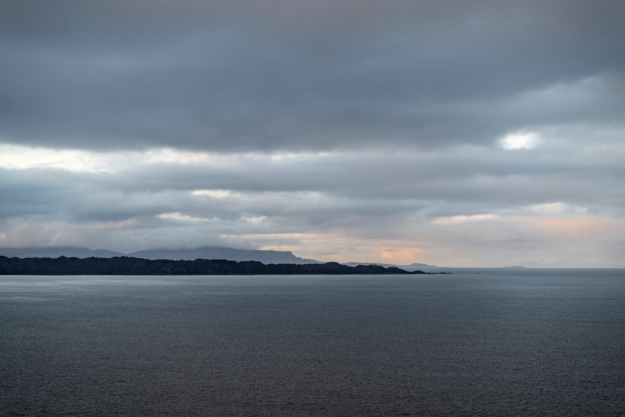 A three shot Bracketed image of late afternoon light and rain across the Inner Sound and South Rona, Scotland. 23 December 2019