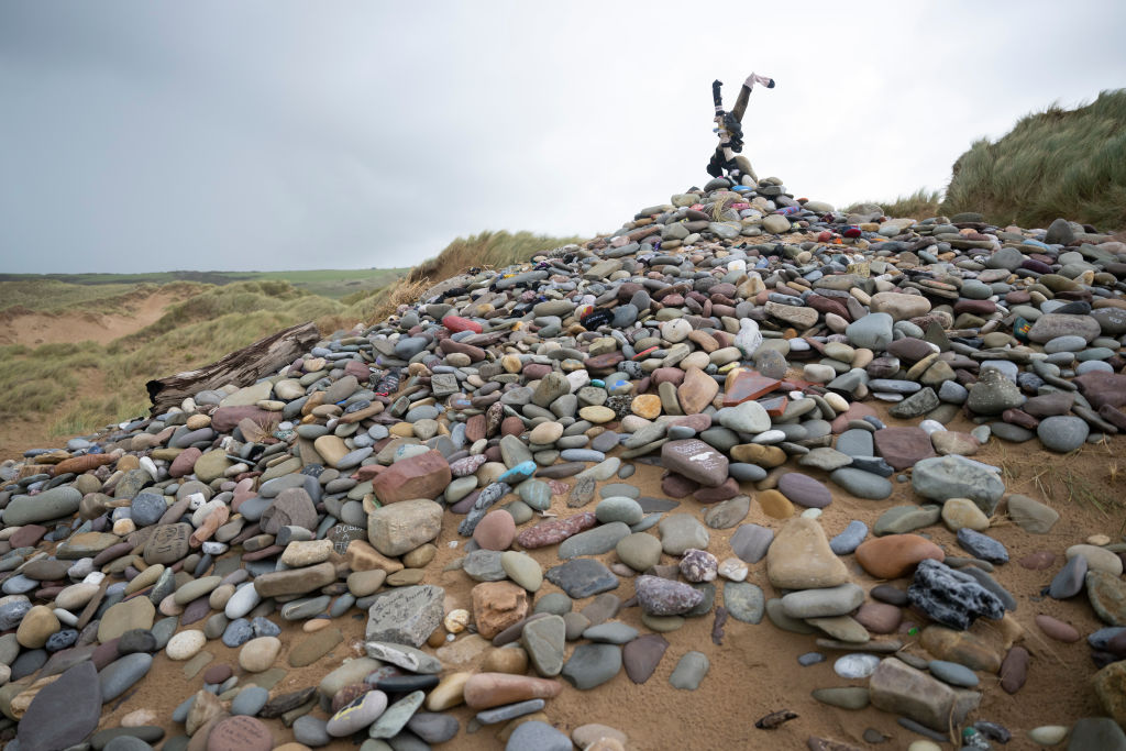A memorial for Dobby, a fictional house elf from the Harry Potter fantasy novels and films, at Freshwater West beach, where the National Trust asked the hundreds of fans who visit each year to stop leaving trinkets including socks and painted stones which can be a hazard to marine life