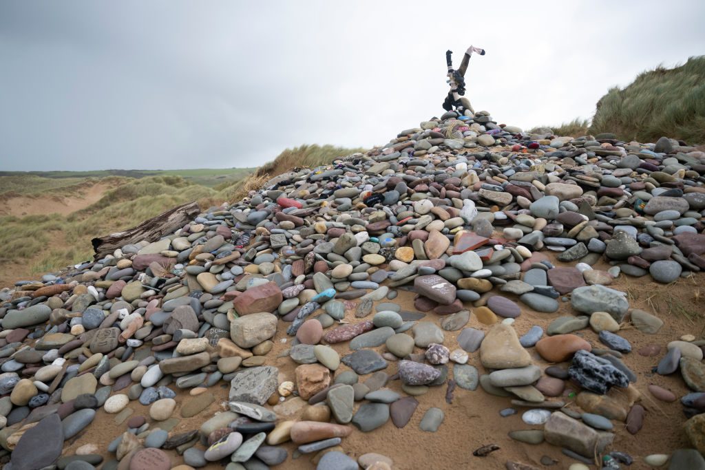 A memorial for Dobby, a fictional house elf from the Harry Potter fantasy novels and films, at Freshwater West beach, where the National Trust asked the hundreds of fans who visit each year to stop leaving trinkets including socks and painted stones which can be a hazard to marine life