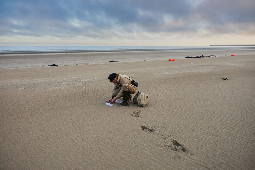 Belgian Aaron Fabrice de Kisangani, 27-years-old beachcomber finds a roadmap abandoned by migrants on the beach of Gravelines, France