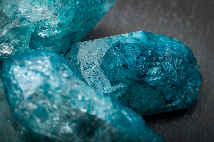 Macro image of raw jewels Closeup of a bunch of many blue rough uncut sapphire crystals