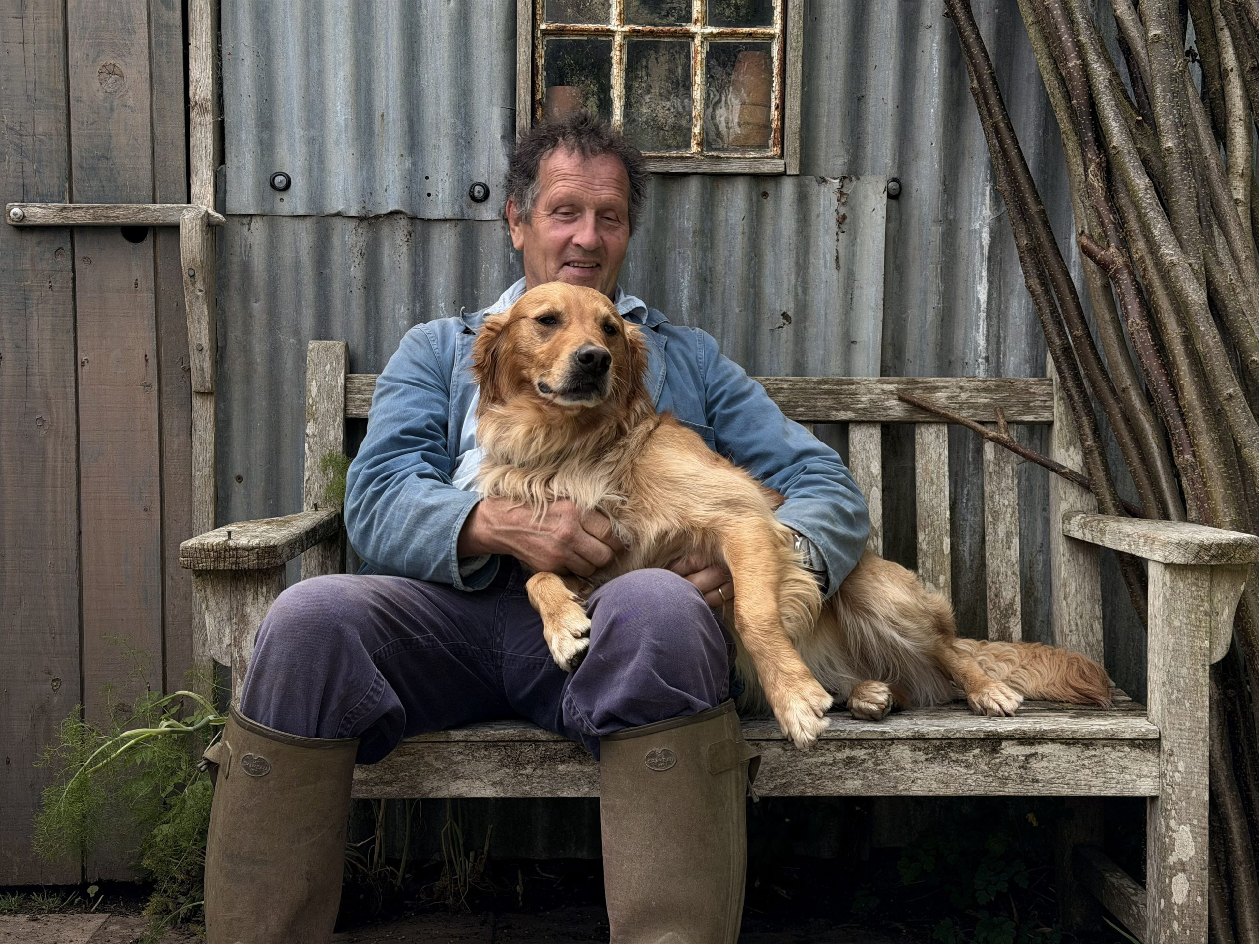 Monty Don and his dog sat on a bench