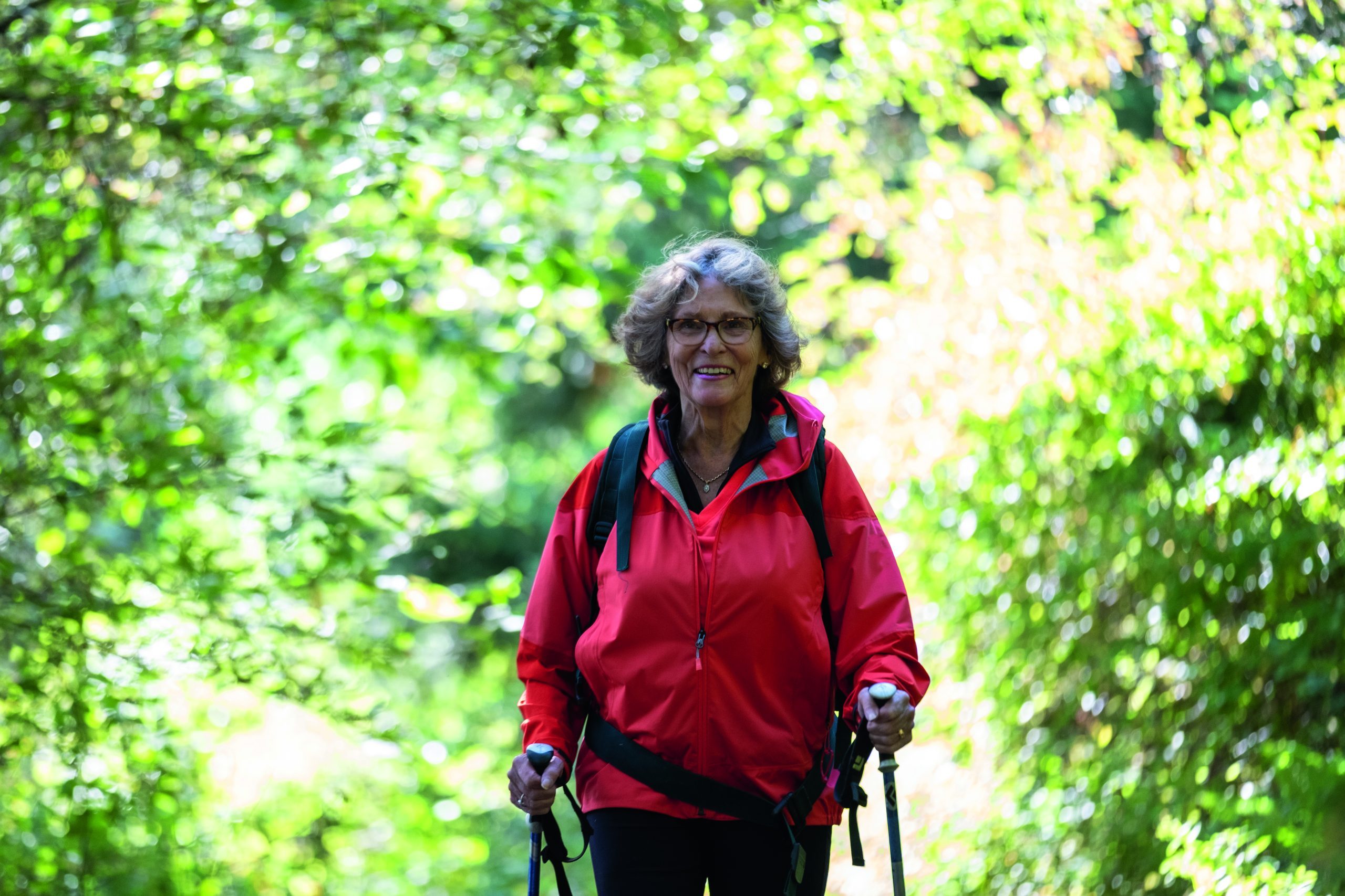 Active women in retirement. Aging in a modern world. Senior woman enjoying her hike in nature.