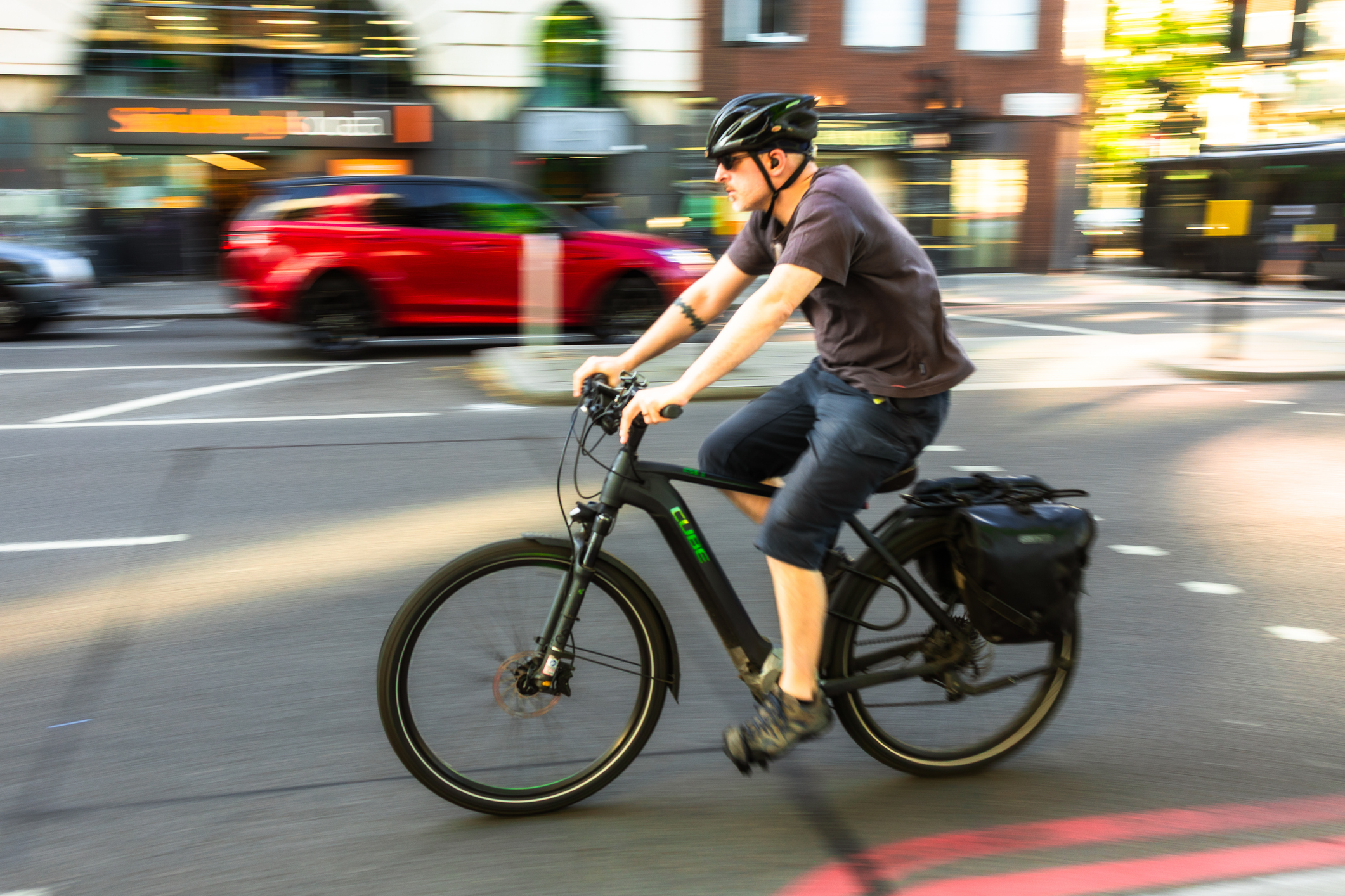 A man riding an electric bike through a city