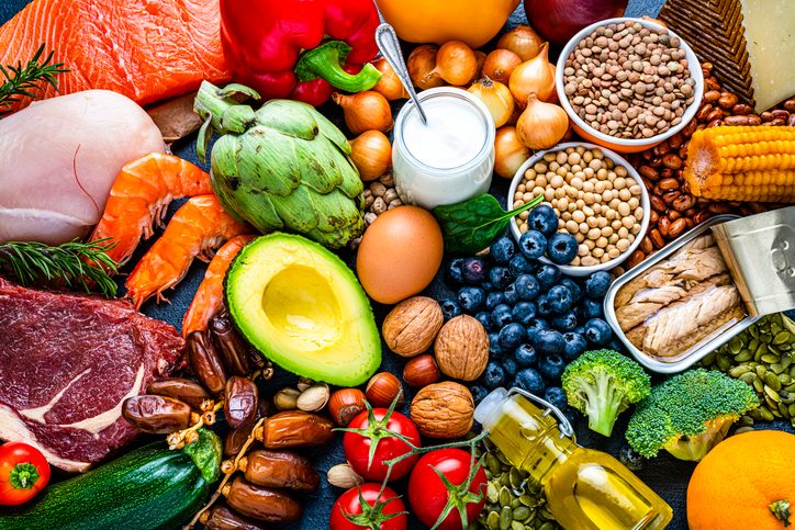 Food group for cholesterol. Overhead view of a large group of healthy raw food for flexitarian mediterranean diet. The composition includes salmon, chicken breast, canned tuna, cow steak, fruits, vegetables, nuts, seeds, dairi products, olive oil, eggs and legumes. High resolution 42Mp studio digital capture taken with SONY A7rII and Zeiss Batis 40mm F2.0 CF lens