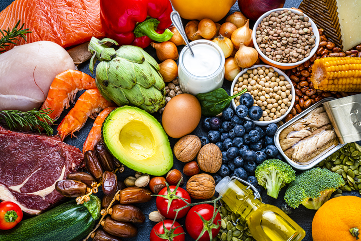 Food group for cholesterol. Overhead view of a large group of healthy raw food for flexitarian mediterranean diet. The composition includes salmon, chicken breast, canned tuna, cow steak, fruits, vegetables, nuts, seeds, dairi products, olive oil, eggs and legumes. High resolution 42Mp studio digital capture taken with SONY A7rII and Zeiss Batis 40mm F2.0 CF lens