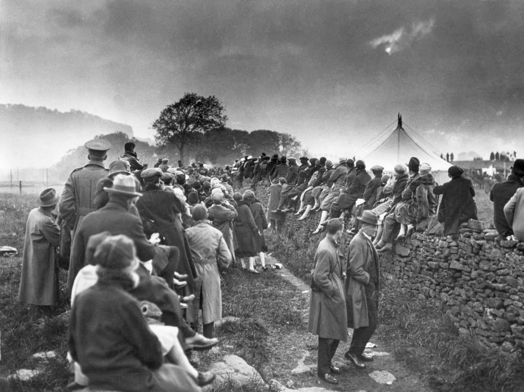 Solar Eclipse black and white scene of people watching sky