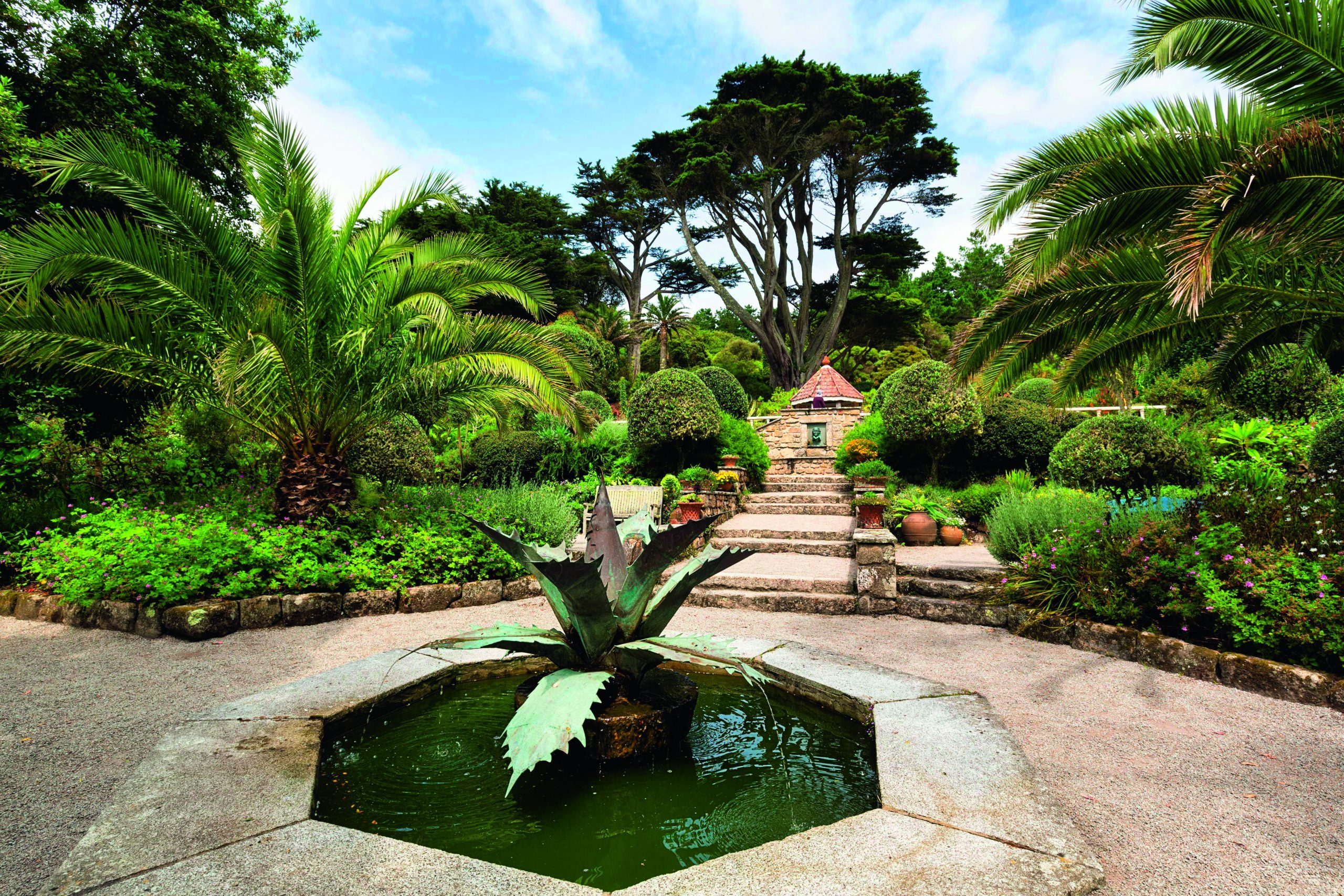 Mediterranean Garden with Fountain, Agave Sculpture, 19th century Subtropical Garden, Tresco Abbey Garden, Isles of Scilly, Cornwall, England, United. 