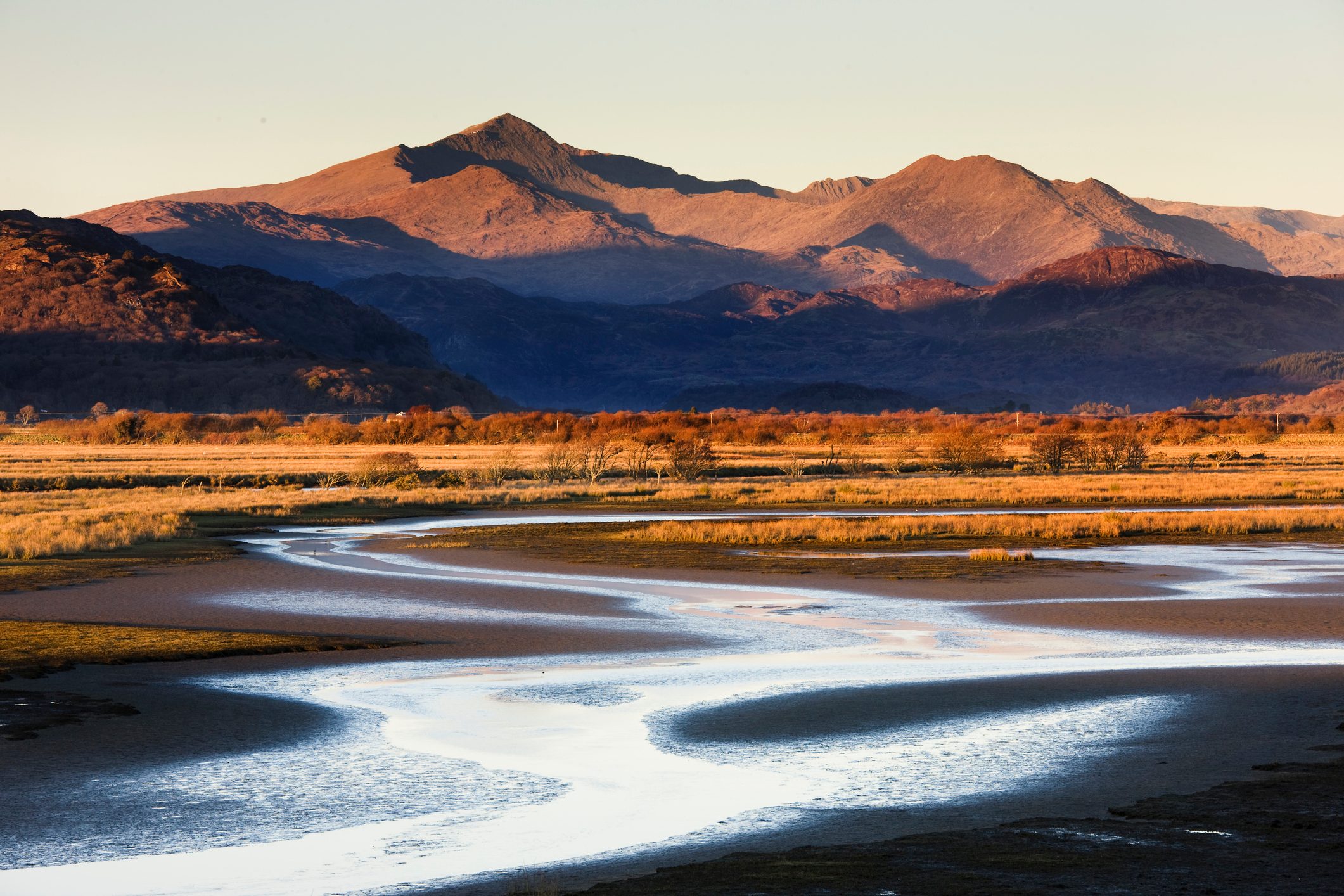 Snowdon seen during the setting evening sun from far away