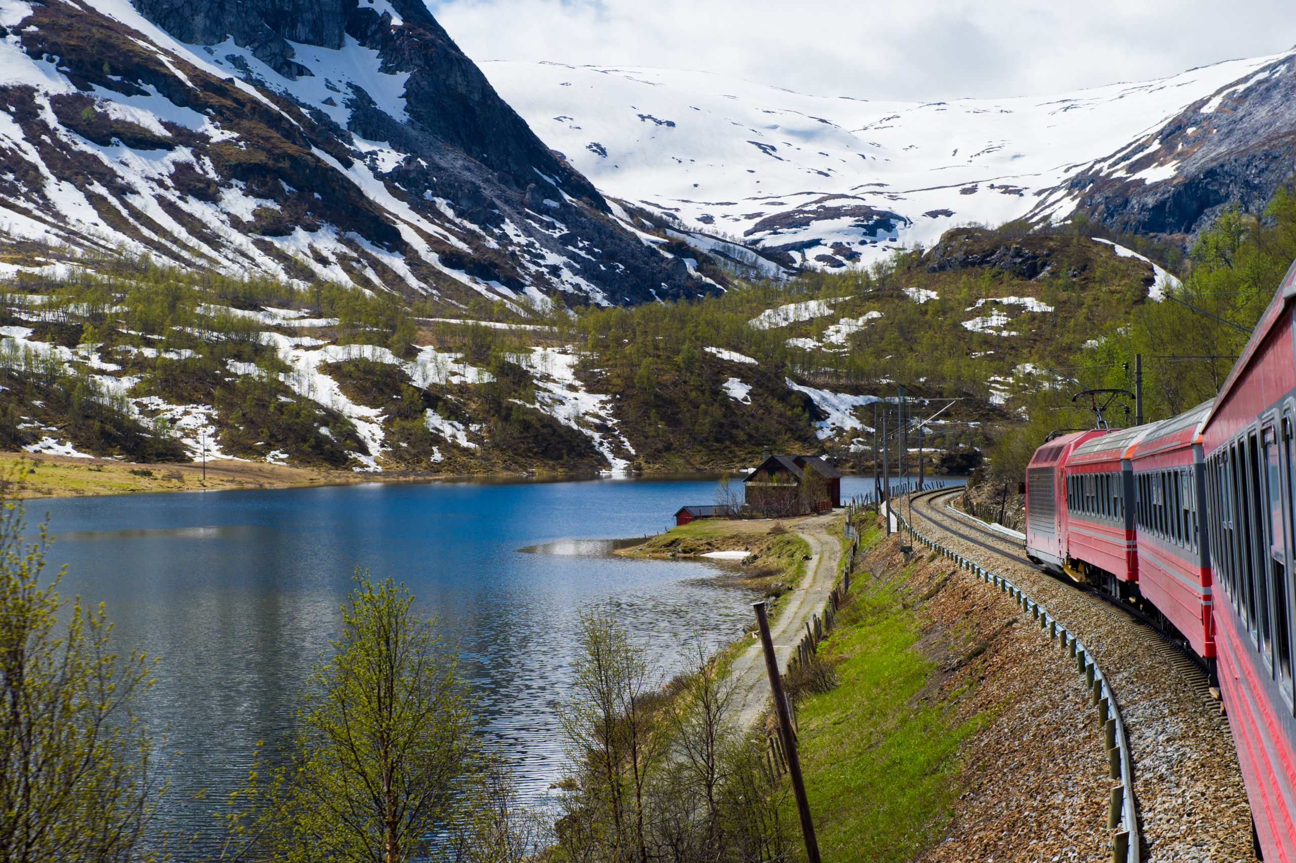 The Bergen train line in Norway going through mountains and past a lake
