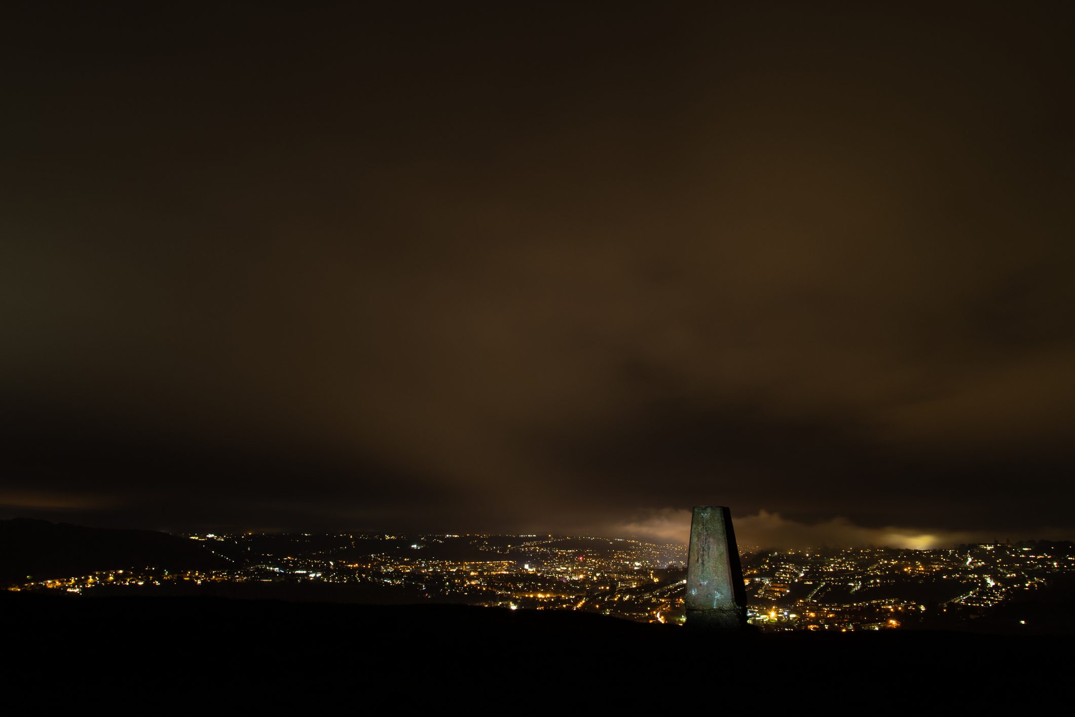 Night view of the UNESCO World Heritage City of Bath, with stone used for cartographic triangulation in foreground