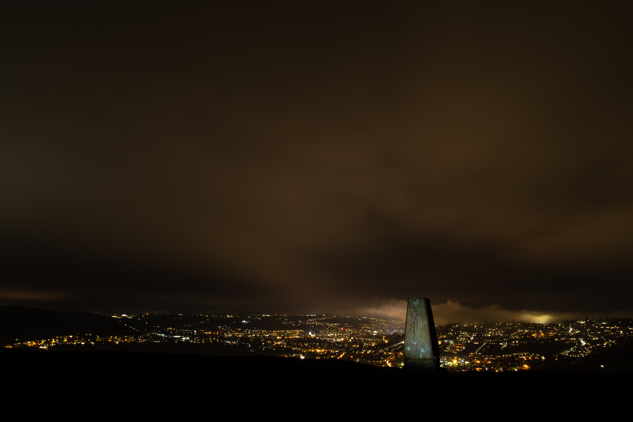 Night view of the UNESCO World Heritage City of Bath, with stone used for cartographic triangulation in foreground