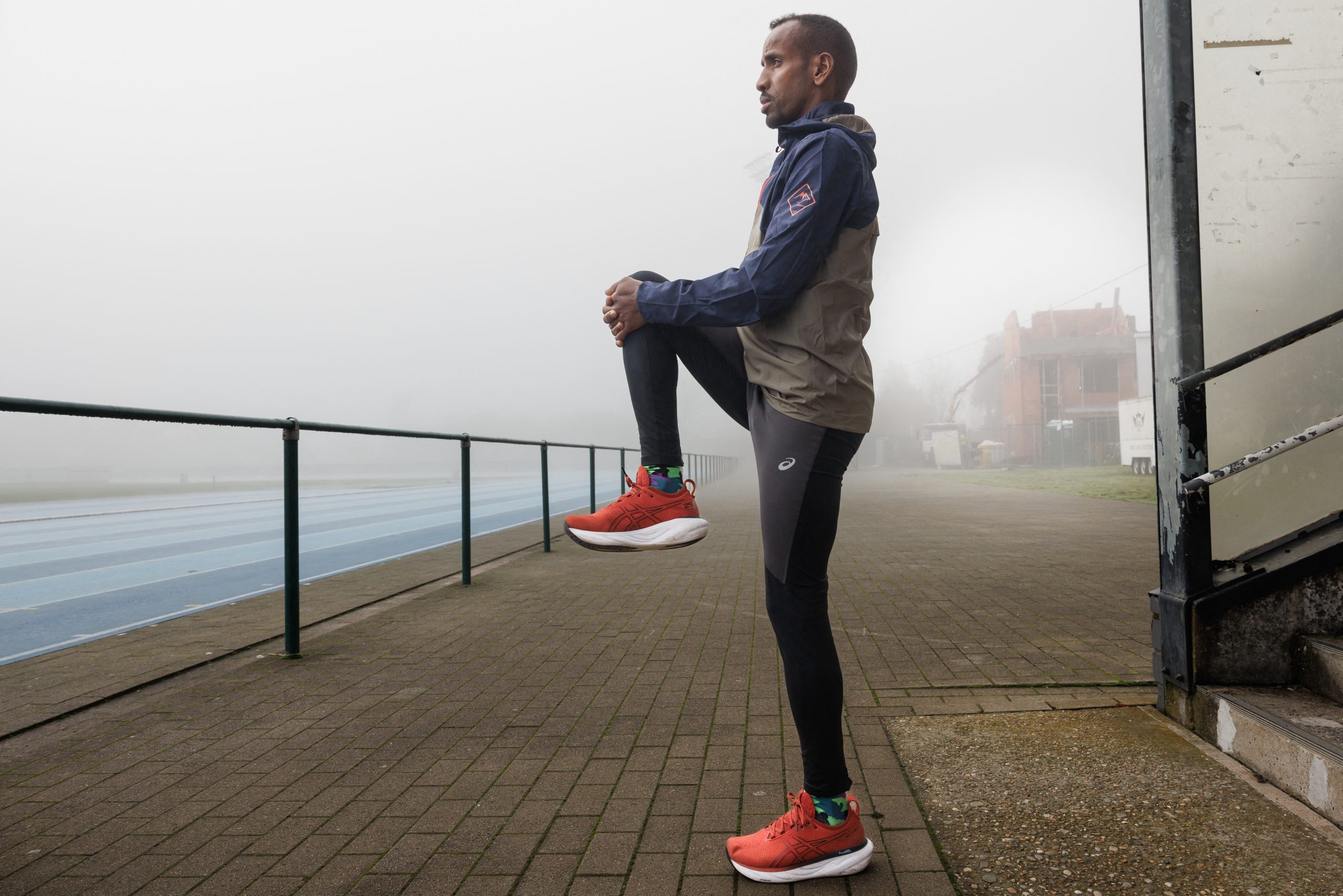 Belgian marathon runner Bashir Abdi stretches at KRCG Atletiek in Gent, on November 30, 2023. The Belgian athlete, qualified for the 2024 Olympic Games in Paris, won bronze medals in the marathon at the 2020 Tokyo Olympics and 2022 World Championships and is the European record holder for marathon. (Photo by SIMON WOHLFAHRT / AFP) (Photo by SIMON WOHLFAHRT/AFP via Getty Images)